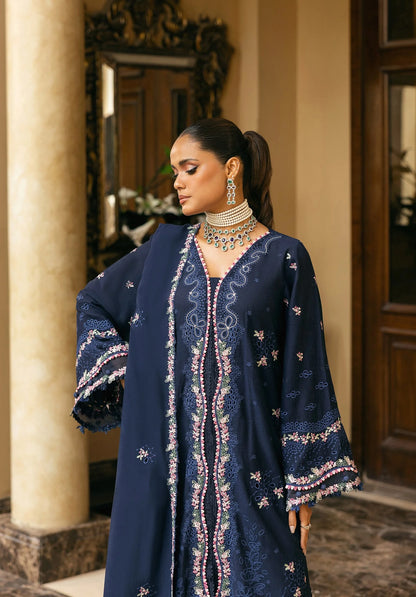 Woman wearing a navy blue embroidered outfit with jewelry in an elegant indoor setting in ELAF LUXURY WINTER.